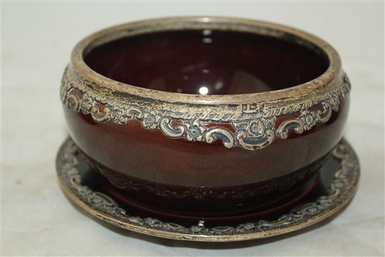 Wedgwood treacle glazed pottery silver mounted part tea set, c.1906, the hot water pot 13cm., one plate broken (13)(-)